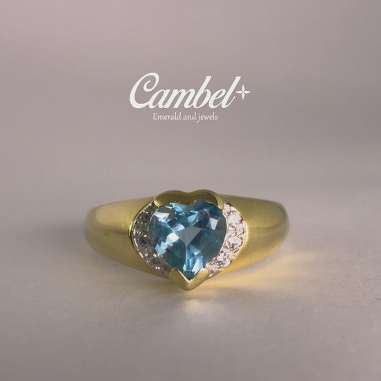 VIdeo en detalle de Anillo de diseño corazón en oro de 18k con un majestuoso topacio Swiss Blue natural y 6diamantes, alta joyería de Cambel